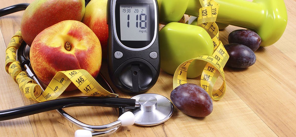 Fresh fruit, blood glucose monitor, measuring tape and stethoscope
